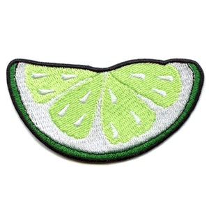 May include: A green lime wedge embroidered patch with a white center and black outline.