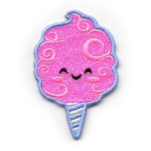 May include: A pink and blue embroidered iron-on patch of a smiling cotton candy with a swirl design.
