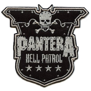 May include: A black and silver embroidered patch with the words "Pantera" and "Hell Patrol" and three stars. A skull with crossbones is above the text.