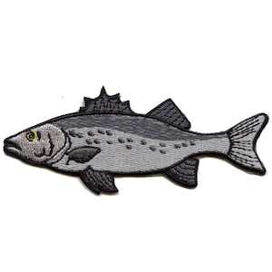 May include: Embroidered patch of a fish in shades of gray and black. The fish has a detailed design with a dorsal fin, tail fin, and eye. The patch is likely for clothing or accessories.