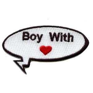 May include: White speech bubble with a black outline and the text "Boy With" in black lettering. A red heart is centered below the text.