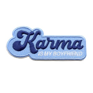 May include: Blue and white embroidered patch with the text "Karma is my boyfriend".