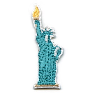 May include: A teal blue embroidered patch of the Statue of Liberty holding a torch. The torch is yellow and the base of the statue is gold.