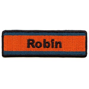 May include: A black embroidered name tag with a blue and orange stripe. The name "Robin" is embroidered in black.