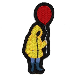 May include: Embroidered iron-on patch featuring a yellow raincoat with a hood, blue jeans, and black boots. The figure is holding a red balloon with a string.