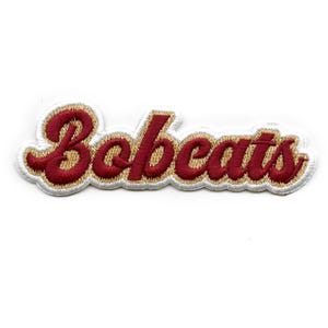 May include: Embroidered patch with the word "Bobcats" in a red script font with a gold outline.