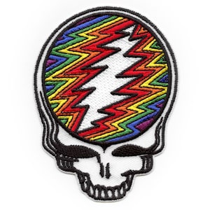Può includere: Una toppa ricamata Grateful Dead Steal Your Face con colori arcobaleno e contorno nero. La toppa è ricamata con un fulmine bianco.