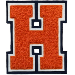 May include: Orange felt letter H with white and navy blue outlining. The letter is in a classic varsity style font.