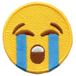 May include: Yellow embroidered patch featuring a crying face emoji. The face has blue tears, a brown mouth, and white eyes.