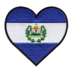 May include: A heart-shaped patch with the flag of Nicaragua. The flag features three horizontal stripes of blue, white, and blue, with the national coat of arms in the center.