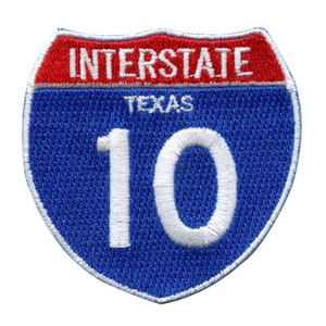 May include: Blue and red Interstate highway sign with the number 10 and the word "Texas" in white lettering.