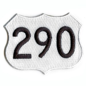 May include: White highway sign with black numbers 290.