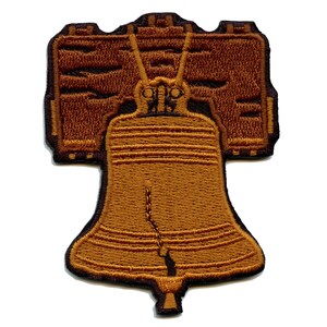 May include: A brown embroidered patch of the Liberty Bell, a symbol of American independence.