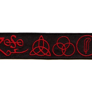 May include: Black rectangular patch embroidered with red thread. The patch features the word "Zeppelin" in a stylized font, along with four symbols. The symbols include a knot, three interlocking circles, and a feather in a circle.