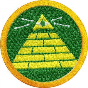 May include: An embroidered patch featuring a pyramid with an eye inside, surrounded by rays of light. The patch is green and yellow with a yellow border.