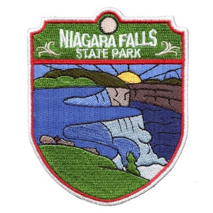 May include: Embroidered patch featuring a green background with the text "Niagara Falls State Park" in white. The patch depicts a stylized image of Niagara Falls with a blue river, green foliage, and a setting sun.