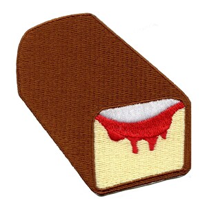 May include: A brown and yellow embroidered patch of a chocolate-covered sponge cake with red jam filling and a drip of jam.