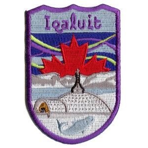 May include: Purple and blue embroidered patch with a red maple leaf, a white igloo, a white fish, and the text "Iqaluit".