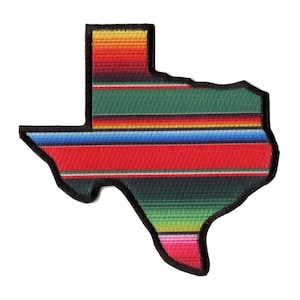 May include: A colorful embroidered patch shaped like the state of Texas. The patch features a traditional Mexican serape pattern with stripes of red, green, blue, yellow, and pink.