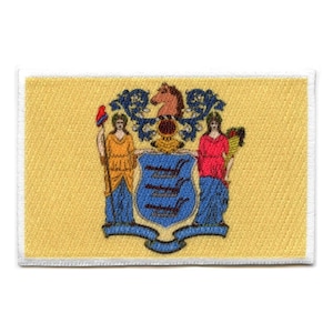 Op de afbeelding: Een gele patch met het staatszegel van New Jersey. Het zegel toont een paard, een schild met drie blauwe balken en twee vrouwen die een scepter en een tarwehalm vasthouden.