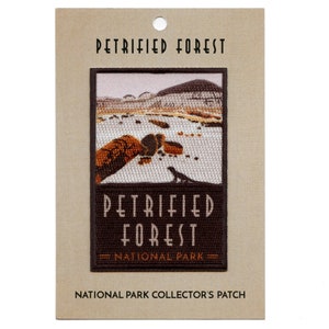 May include: Embroidered patch featuring a landscape scene of the Petrified Forest National Park in Arizona. The patch is brown with white text that reads "Petrified Forest National Park".