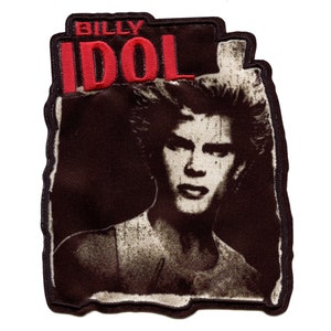 May include: A black and white embroidered patch with the text "BILLY IDOL" in red lettering. The patch features a black and white image of Billy Idol with a mohawk hairstyle.
