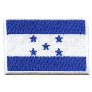 May include: An embroidered patch of the Honduran flag. The flag is blue with a white stripe in the center. Five white five-pointed stars are arranged in a horizontal row on the white stripe.