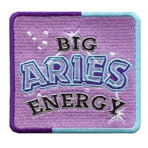 May include: Purple and blue embroidered patch with the text "BIG ARIES ENERGY" in white and black lettering.