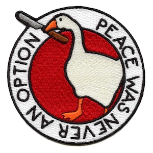 May include: White embroidered patch with a goose holding a knife. The text around the goose reads "Peace Was Never An Option".