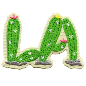 May include: Embroidered iron-on patch featuring the letters "LA" formed by two green cactus plants with white flowers and pink blossoms.