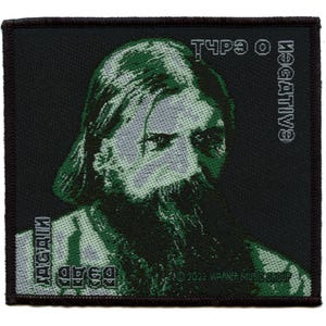 May include: A black and green embroidered patch with the text "Type O Negative" and a portrait of a man with a beard. The text "Bloodstains" is also visible on the patch.