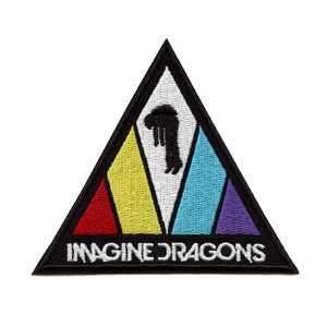 May include: Black triangular patch with a white center featuring a silhouette of a person with their head down. The triangle is outlined in black and has a rainbow of colors at the bottom. The text "Imagine Dragons" is printed in white at the bottom of the patch.