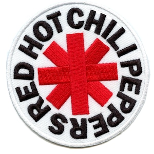 May include: Red Hot Chili Peppers logo patch with a white background and black text. The logo features a red asterisk in the center.