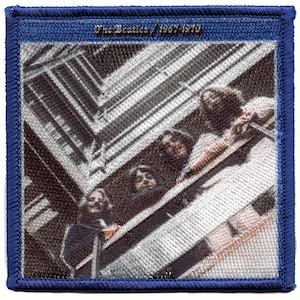 May include: A vintage-style patch featuring a black and white photo of The Beatles, with the text "The Beatles 1962-1970" in blue above the image.