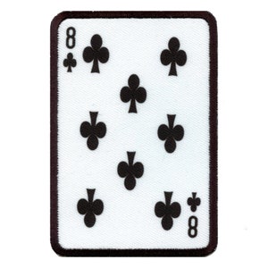 May include: A rectangular patch featuring the eight of clubs playing card design. The card has a white background with eight black club symbols and the number 8 in the corners. The patch is bordered with a dark brown trim.