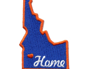 May include: An embroidered patch in the shape of the state of Idaho with an orange outline. The patch is blue with a white heart and the word "Home" in white cursive lettering.