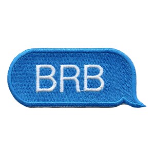 May include: Blue and white embroidered patch with the text "BRB" in a speech bubble shape.
