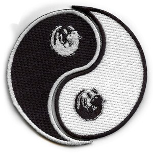 May include: Black and white yin yang symbol with a white wolf on the black side and a black wolf on the white side.