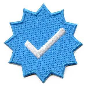 May include: A blue starburst-shaped patch with a white checkmark in the center.