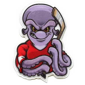 May include: Purple octopus cartoon character wearing a red jersey with white stripes and holding a hockey stick. The octopus has a menacing expression with yellow eyes.