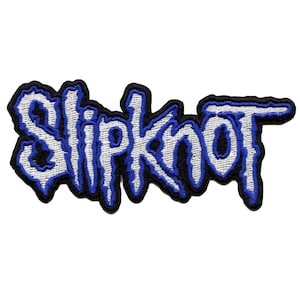 May include: A white embroidered patch with the word "Slipknot" in blue lettering. The patch is on a white background.