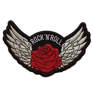 May include: Black embroidered patch with a red rose and white wings. The text "Rock 'n' Roll" is written in a circle around the rose.