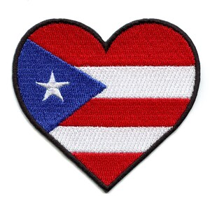 May include: A red, white, and blue heart-shaped patch with the flag of Puerto Rico. The flag features a white star on a blue triangle in the upper left corner, with five alternating red and white stripes.
