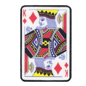 May include: A white playing card with a black border. The card is the King of Diamonds. The King is depicted in a red and blue suit with a crown on his head. The card has a white background with red and blue accents.