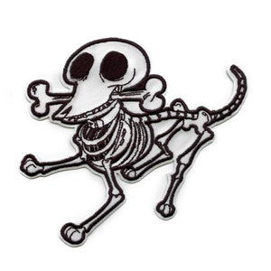 May include: Black and white embroidered patch of a cartoon skeleton dog with a bone in its mouth. The dog is running and has a happy expression.
