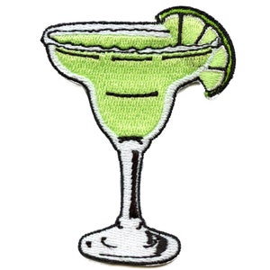 May include: A green margarita glass with a lime wedge on the rim. The glass is filled with a green liquid and has a white rim. The glass is on a white background.