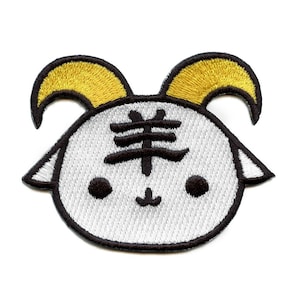 May include: White embroidered patch with a black outline of a cartoon sheep with yellow horns. The sheep has a black Chinese character for "sheep" on its forehead.