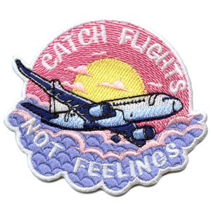 May include: Embroidered iron-on patch featuring a pink sunset and a white aeroplane flying above blue clouds. The text reads "Catch Flights Not Feelings".