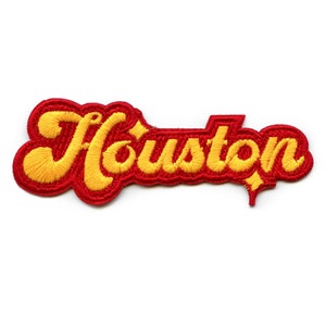 May include: Red and yellow embroidered patch with the word "Houston" in a retro font.