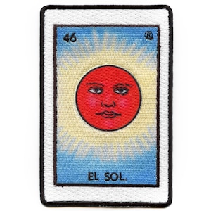 May include: A vintage-style embroidered patch featuring a red sun with a face, surrounded by yellow rays. The patch has a blue background with white borders and the text "EL SOL" and the number "46" in black.